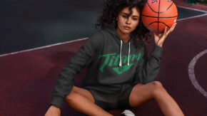 girl holding basketball and wearing tech hoodie with 