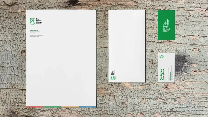 parks alliance business system including letterhead, envelop, and business card on a wooden background