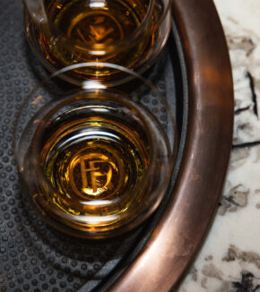 fortunes fool icon at the bottom of a glass of whiskey