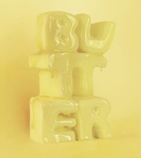 butter sculpted into the word butter and slightly melted