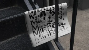 a newspaper folded in half with a mirror indy logo on it