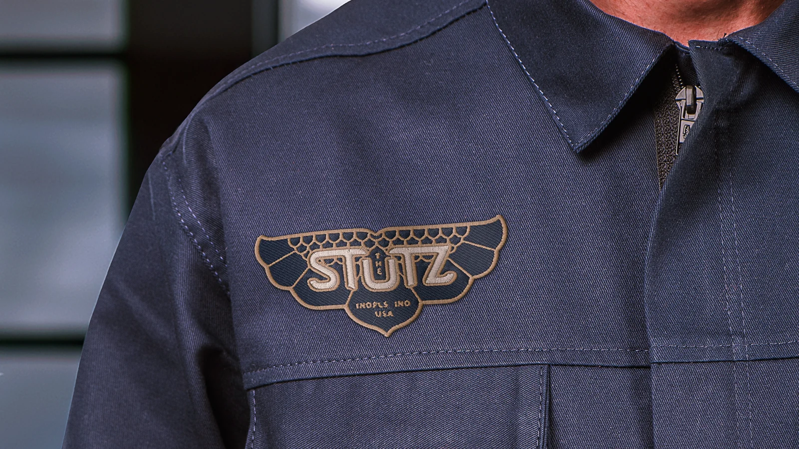 the-stutz-someraroad close up of branded coveralls