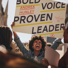 a woman carrying an andrea hunley sign