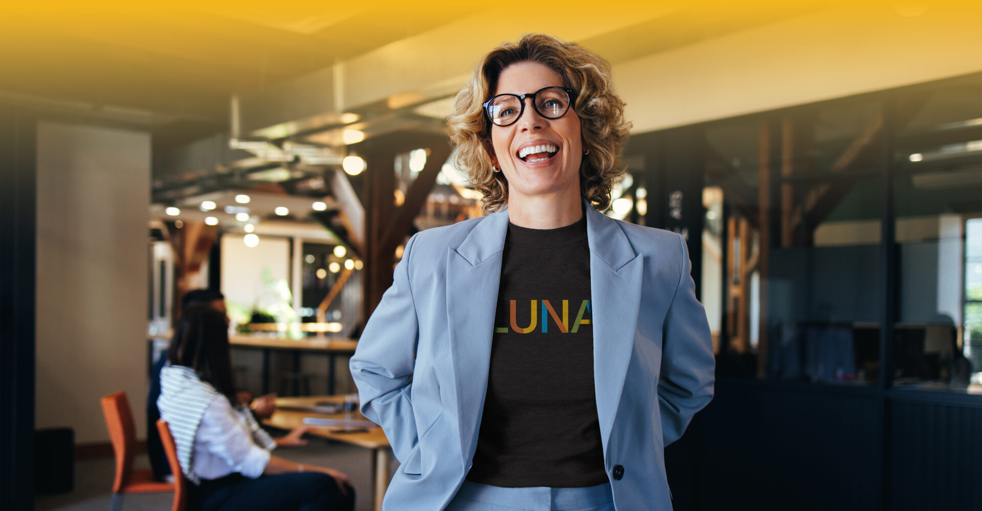 Latina woman in a blue blazer with a shirt underneath that says 