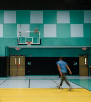 Man Playing Basketball on Court at Nomad Coworking Studio