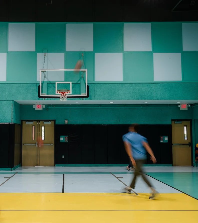 Man Playing Basketball on Court at Nomad Coworking Studio