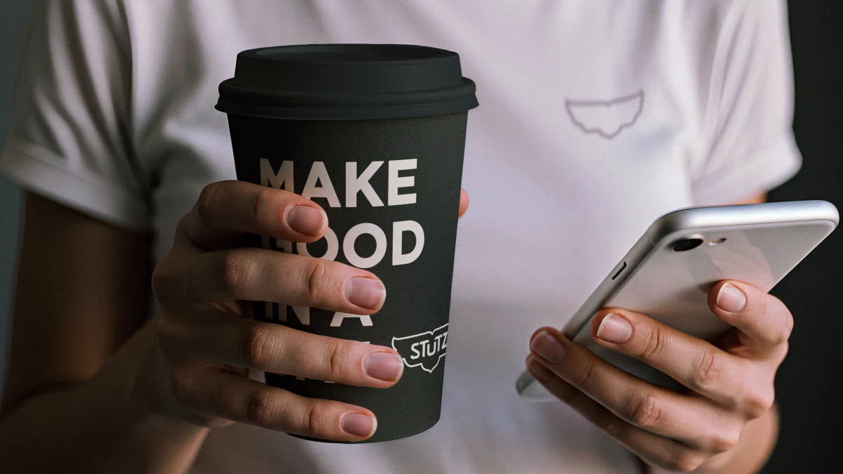 the-stutz-someraroad woman holding branded coffee cup