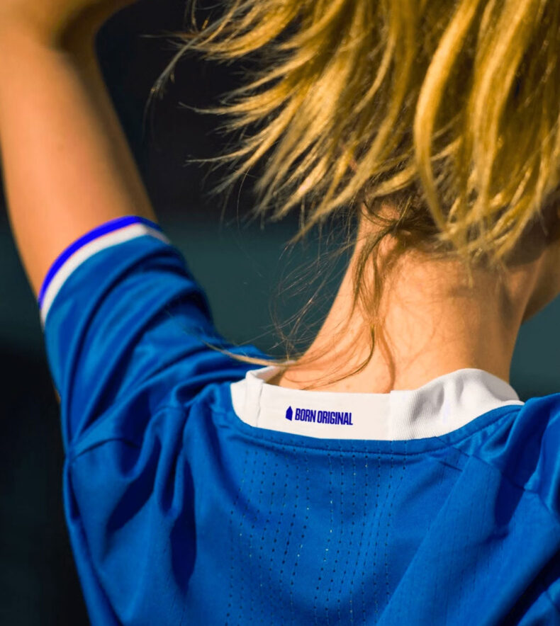 the back collar of an everton jersey with a new slogan