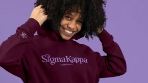 a woman wearing a sigma kappa hoodie