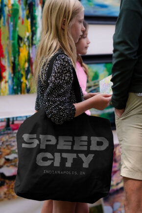 a girl carrying a black speed city branded tote